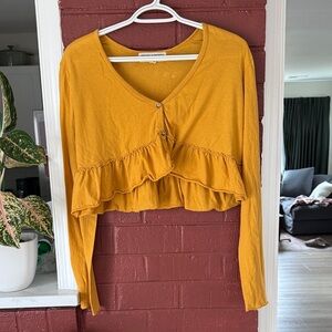 UO Project Social T Cropped Mustard Ruffle-Front Long Sleeve Top